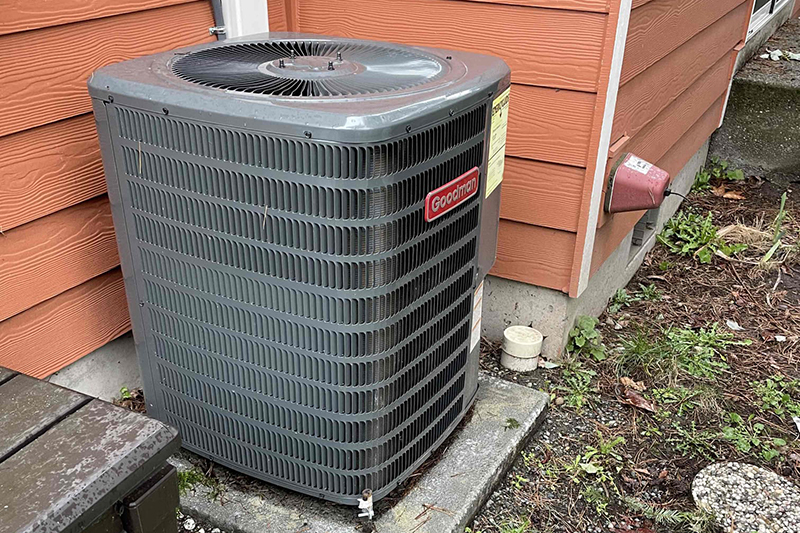 Outdoor unit on the side of a house.