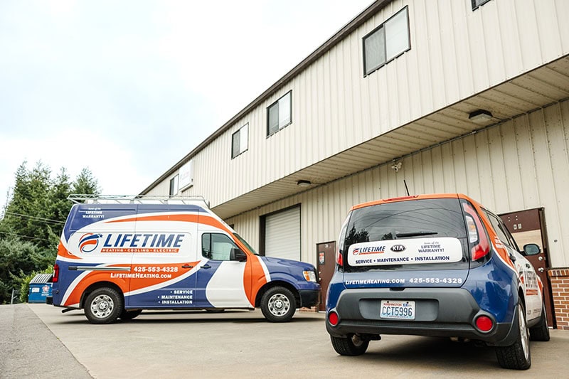 Lifetime company vehicles outside of warehouse.