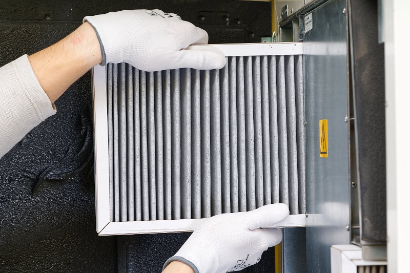 HVAC filter replacing. Replacing the filter in the central ventilation system, furnace. Replacing Dirty Air filter for home central air conditioning system. Change filter in rotary heat exchanger recuperator.