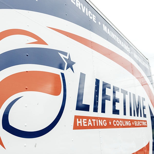 Lifetime Heating, Cooling, Plumbing & Electric logo on the side of their box truck.