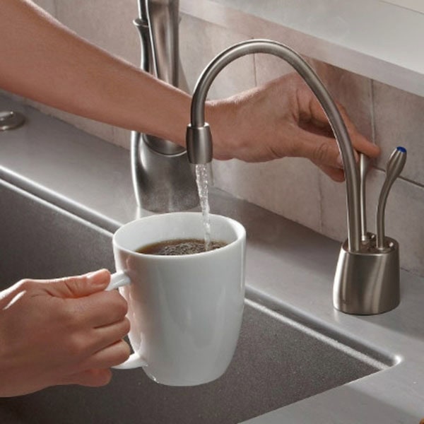 Residential kitchen faucet with running water.