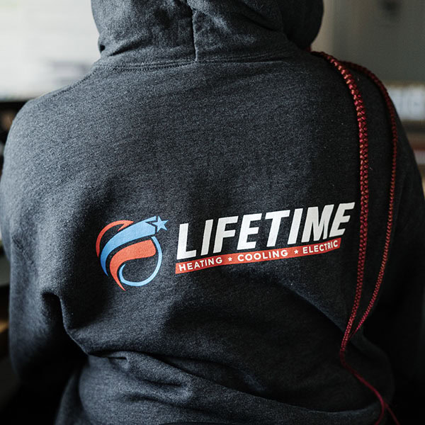 Lifetime Heating, Cooling, Plumbing & Electric logo on back of sweatshirt.