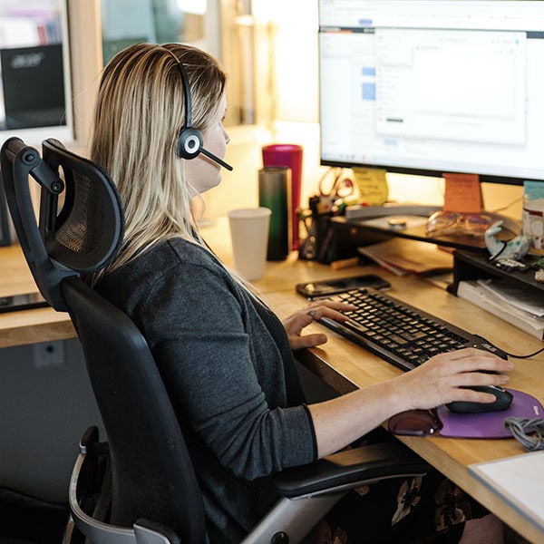 Lifetime Heating, Cooling, Plumbing & Electric customer service representative working on computer.
